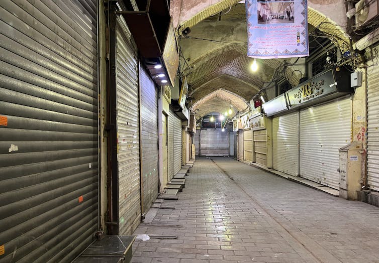 How social media is channeling well-liked discontent in Iran throughout ongoing duration of home unrest 1 An empty indoor market shown with closed shop stalls.