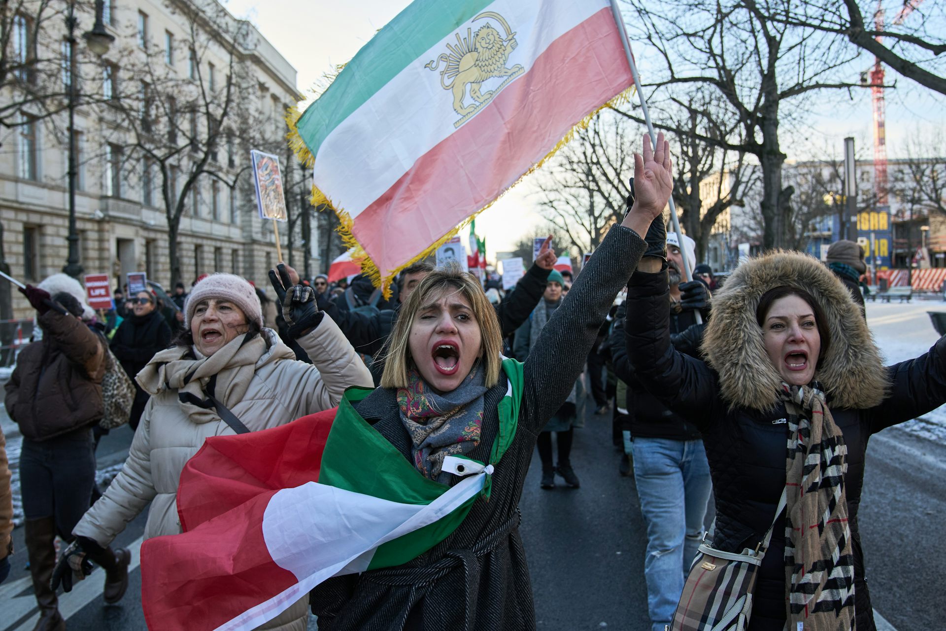 Protesters wave an Iranian flag