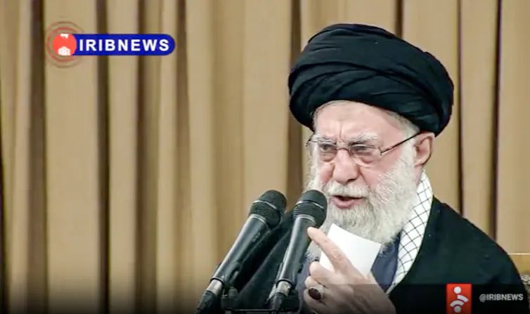 A man speaks into two microphones