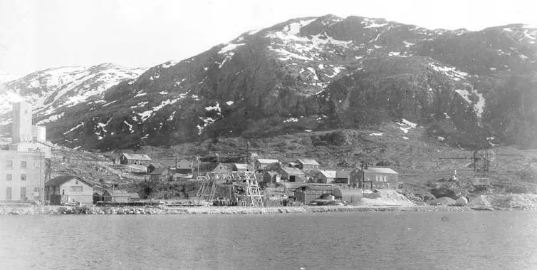 A view across the water to a small mining outpost.