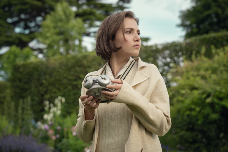 Mia McKenna Bruce holding a clock