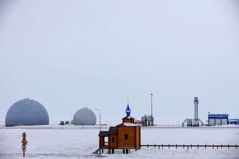 An orthodox church sits in front of the radar facility at Russia's northernmost military base at Nagurskoye in the Arctic.