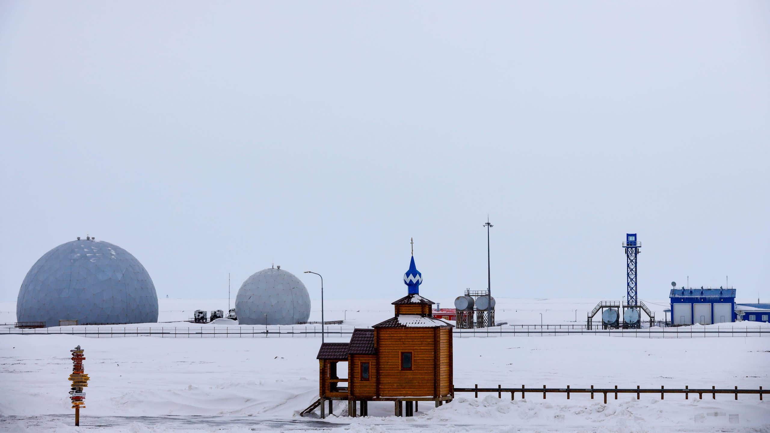 An orthodox church sits in front of the radar facility at Russia's northernmost military base at Nagurskoye in the Arctic.