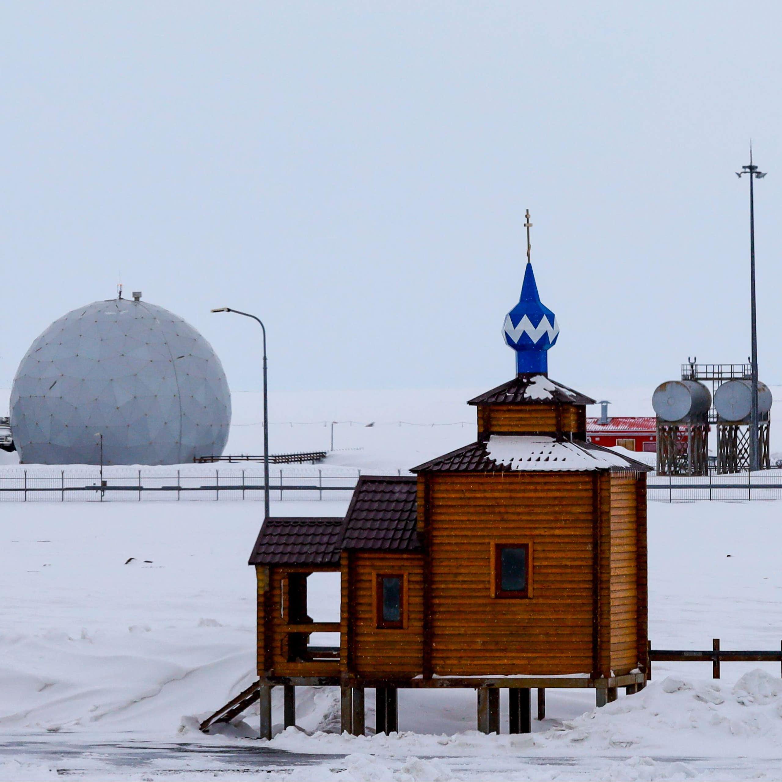 An orthodox church sits in front of the radar facility at Russia's northernmost military base at Nagurskoye in the Arctic.