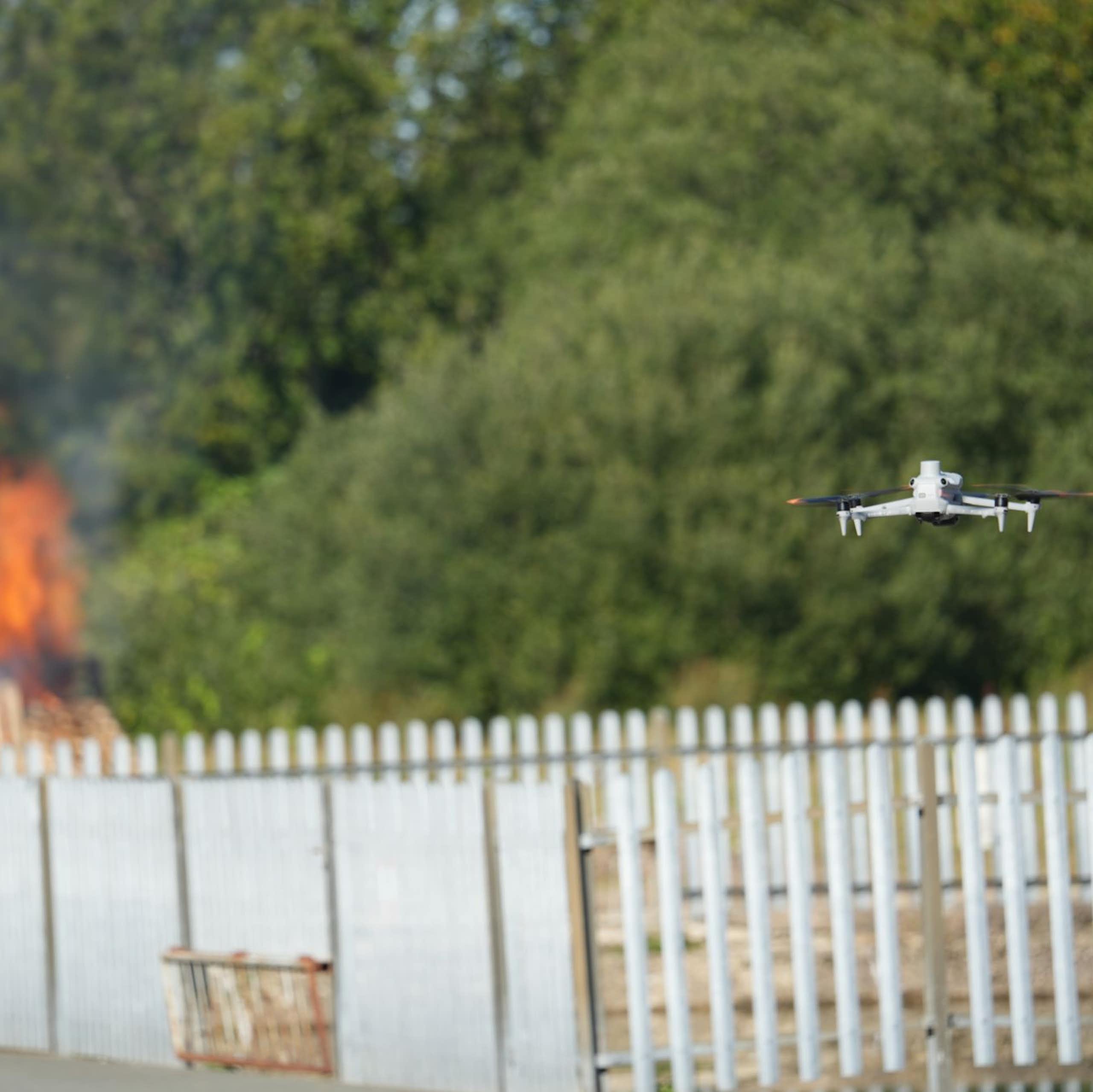 A drone approaches a test fire.