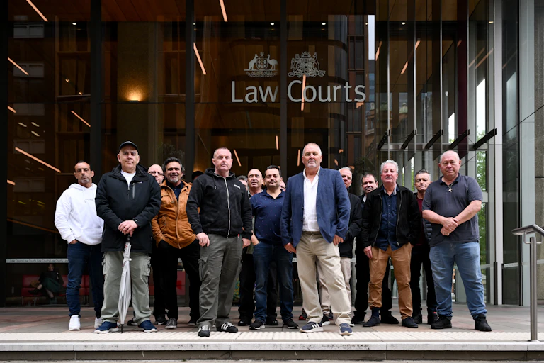 A group of former Qantas workers outside the Federal Court of Australia in Sydney