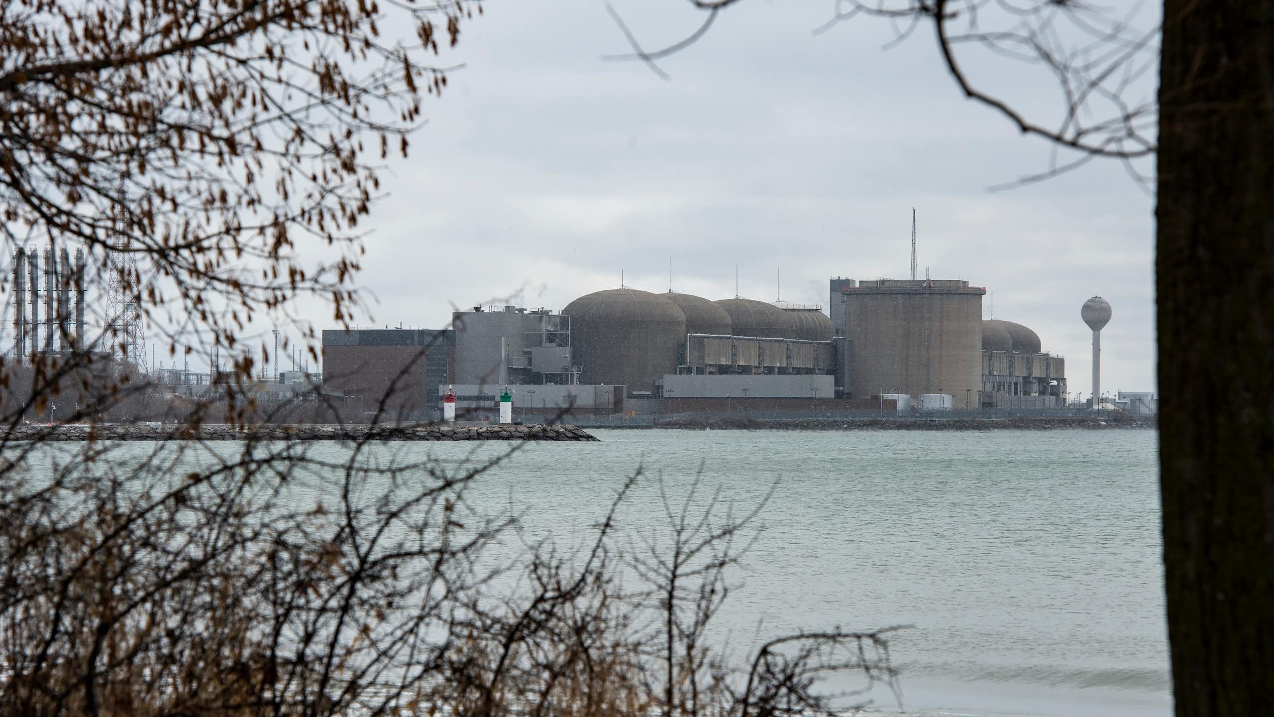 A group of large grey concrete structures near the banks of a body of water