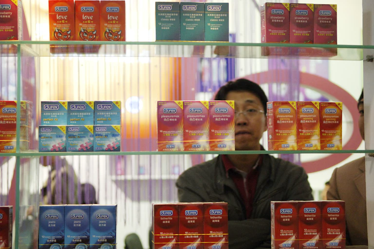 A man looks at a display of condom packages.