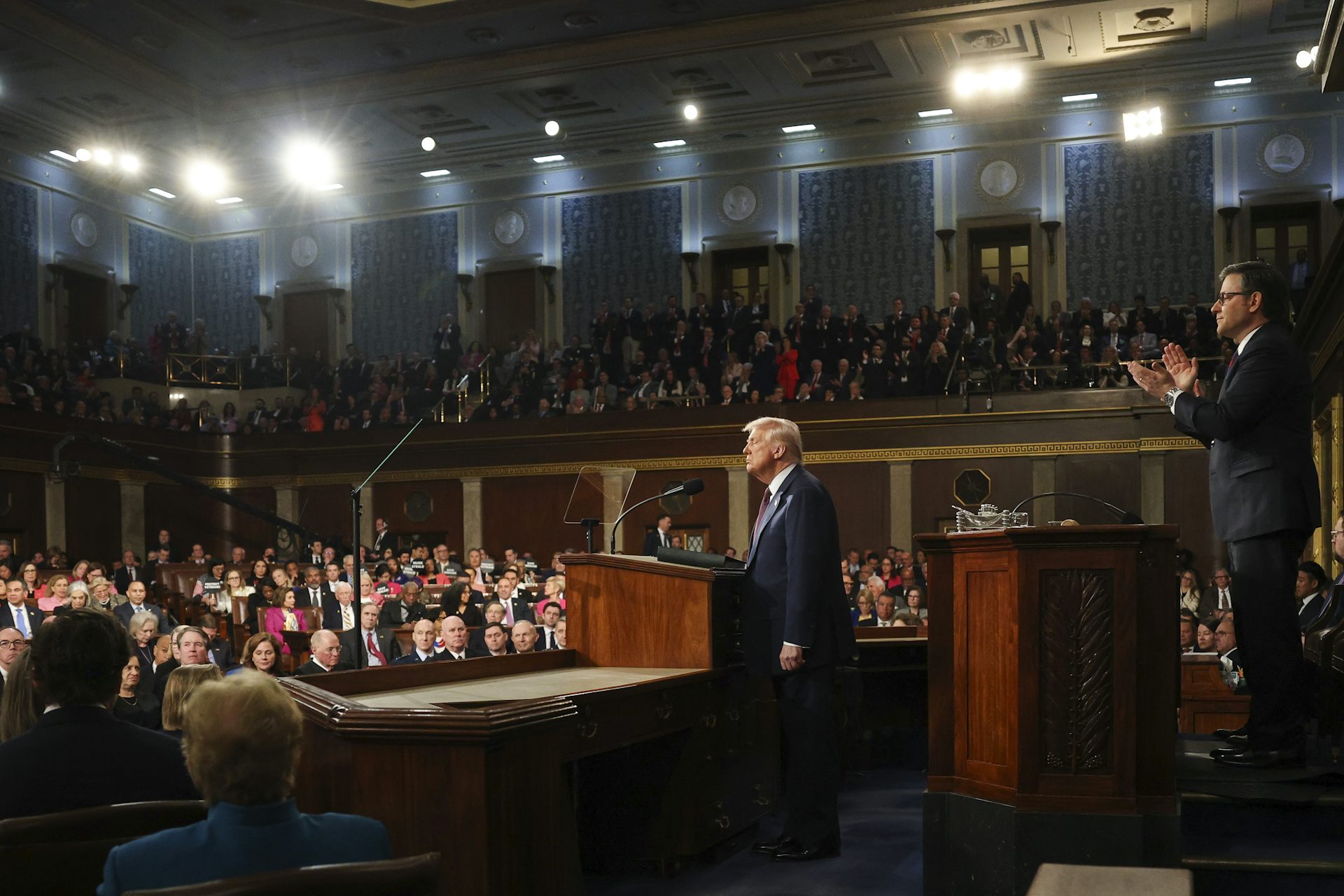 Donald Trump stands on the stage in front of a packed gathering of US congress