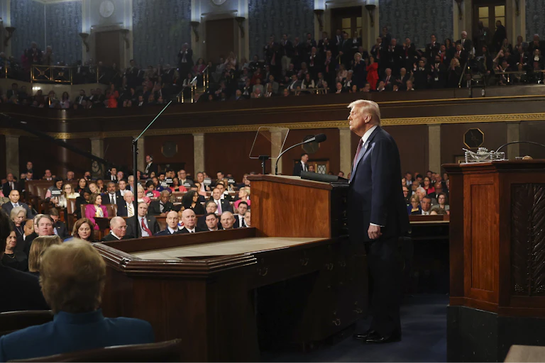 Donald Trump stands on the stage in front of a packed gathering of US congress