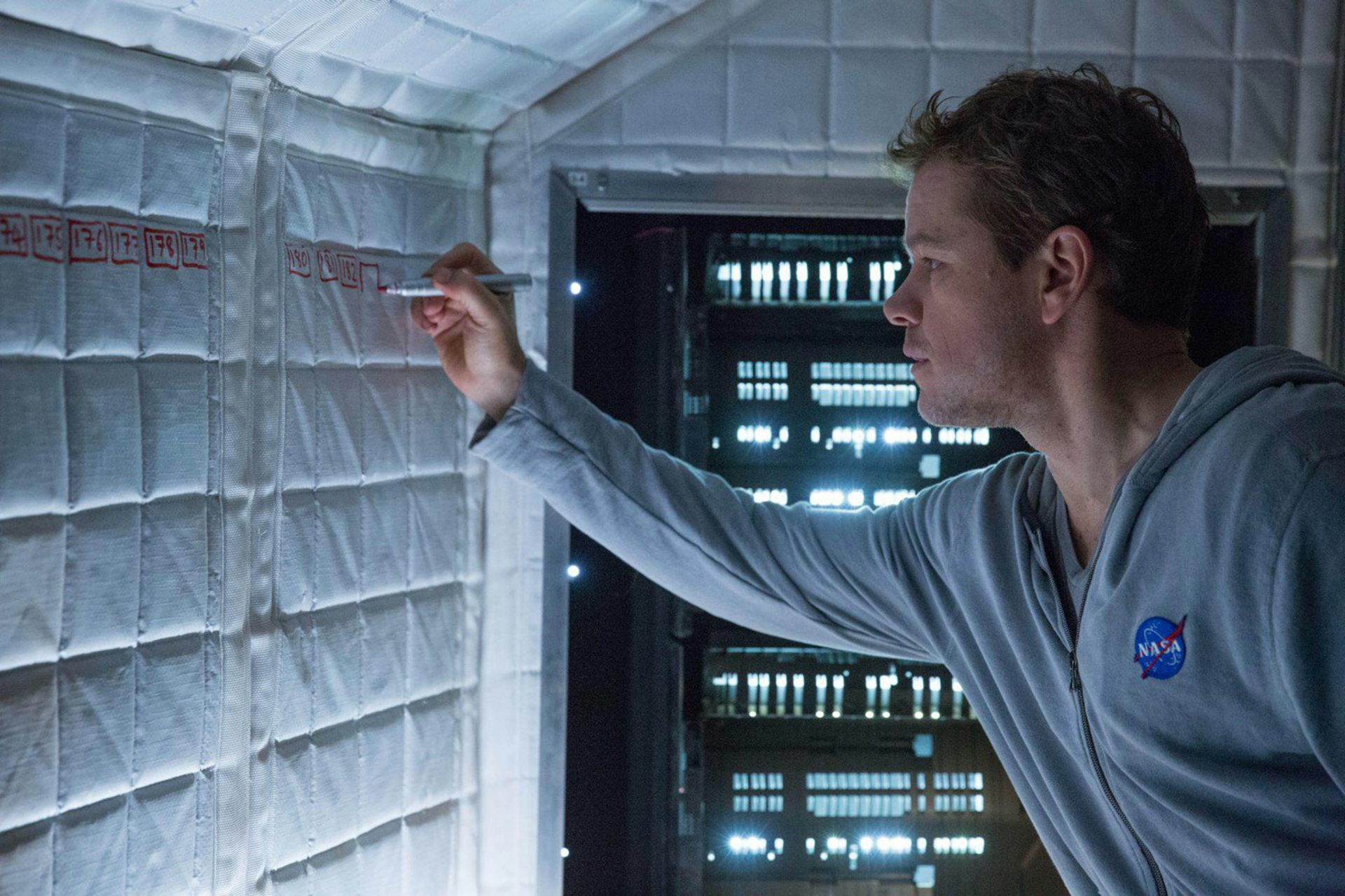 A still of Matt Damon writing on a wall from The Martian
