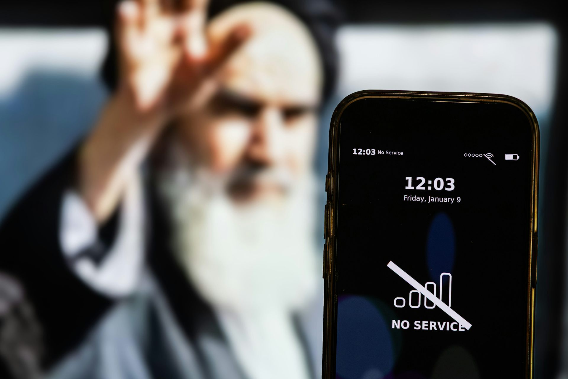 A composite picture showing Iran's supreme leader Ali Khamenei with a smartphone in the foreground with a message about an internet outage.