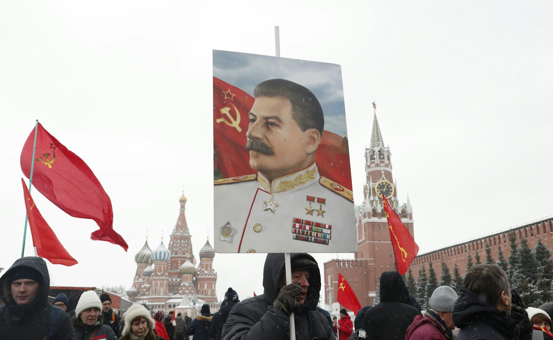Russian Communist party supporter holds a portrait of Joseph Stalin during a wreath laying ceremony.