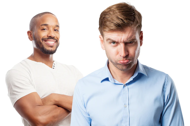 Two men standing next to each other, one smiling the other grimacing.