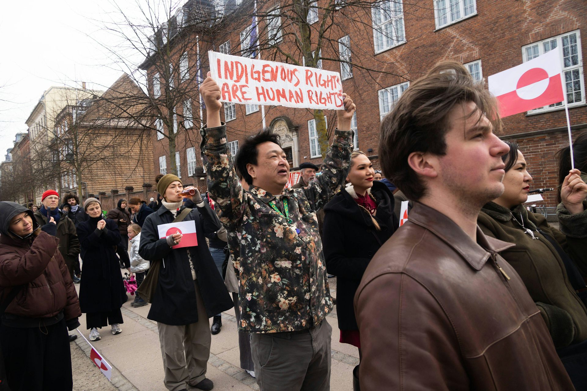 A person carries a placard saying. 'Indigenous rights and human rights' during a demonstration in from of the US embassy in Copenhagen