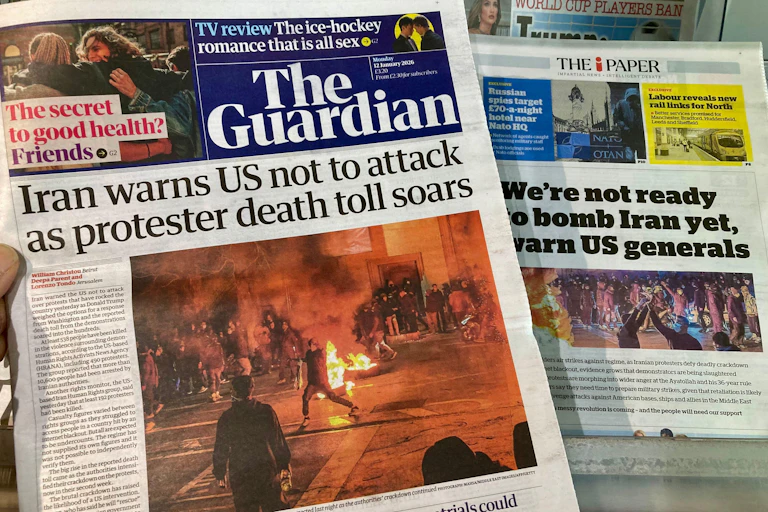 Front pages of the UK's Guardian and Independent newspapers dealing with the situation in Iran January 15 2026.