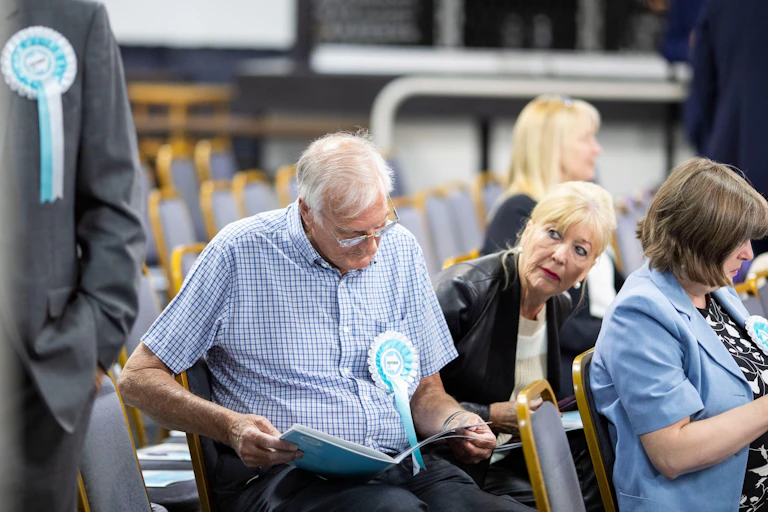 Reform activists reading over documents at a meeting.