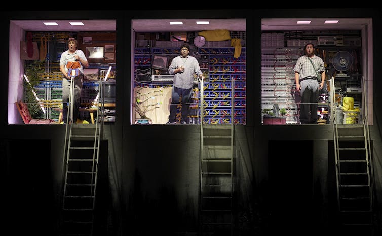 The three nerdy men stand in three boxes.