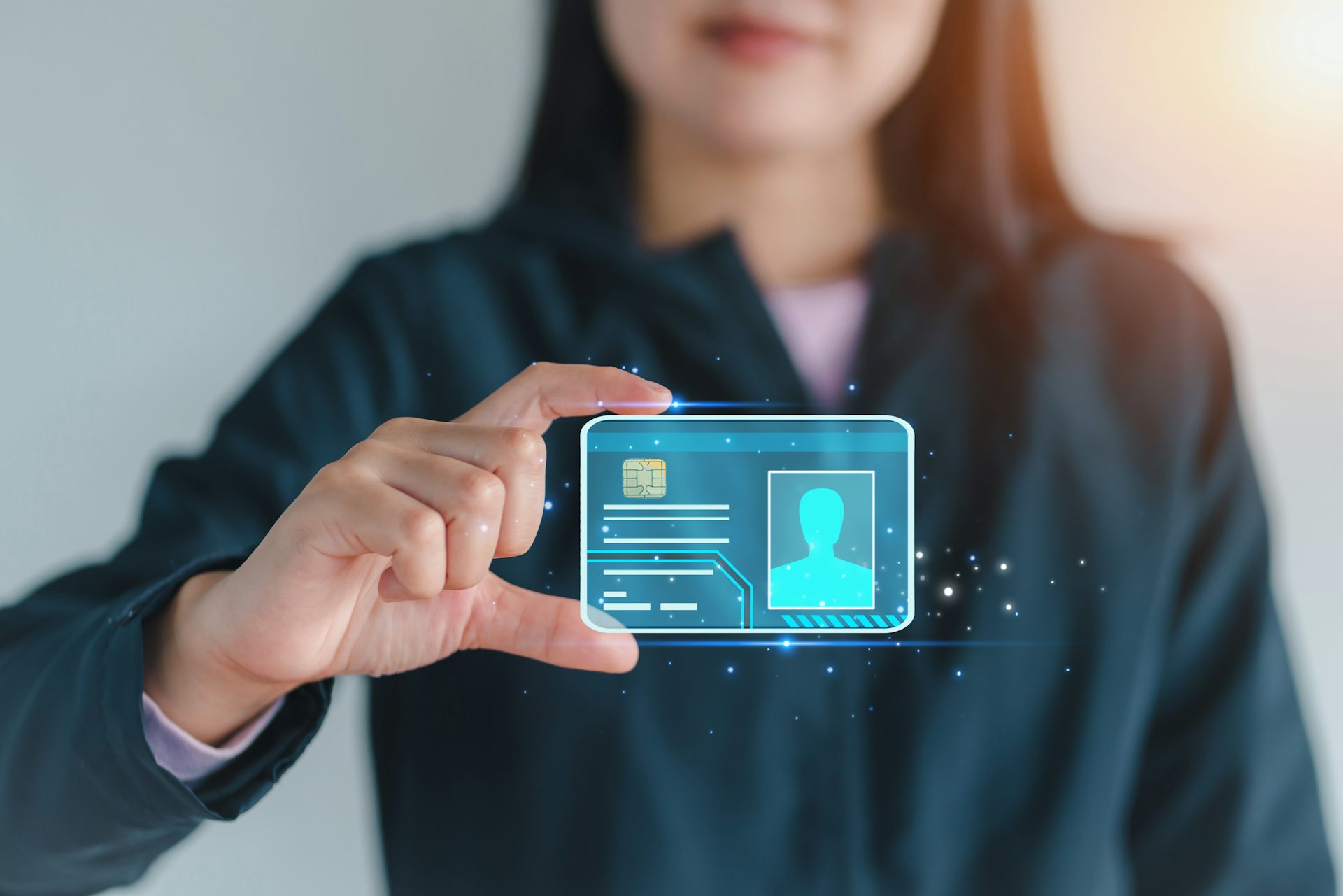A woman appearing to hold a hologram of a digital ID card floating in the air