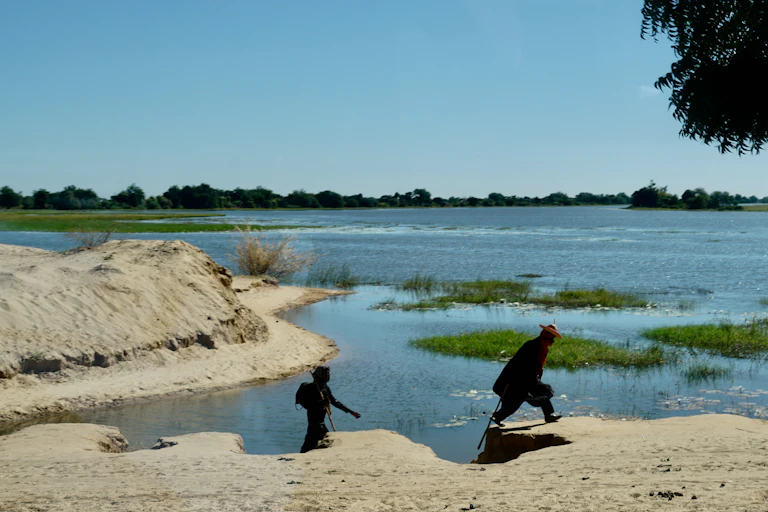 People at the bank of a lake