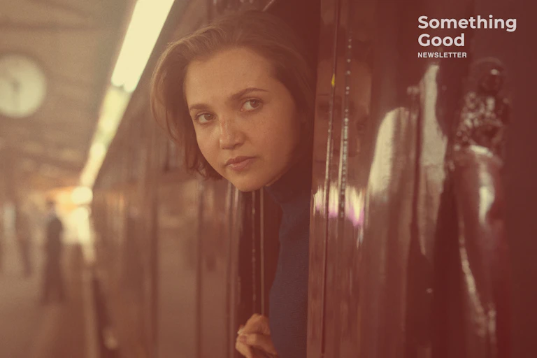 Girl looks out of train.