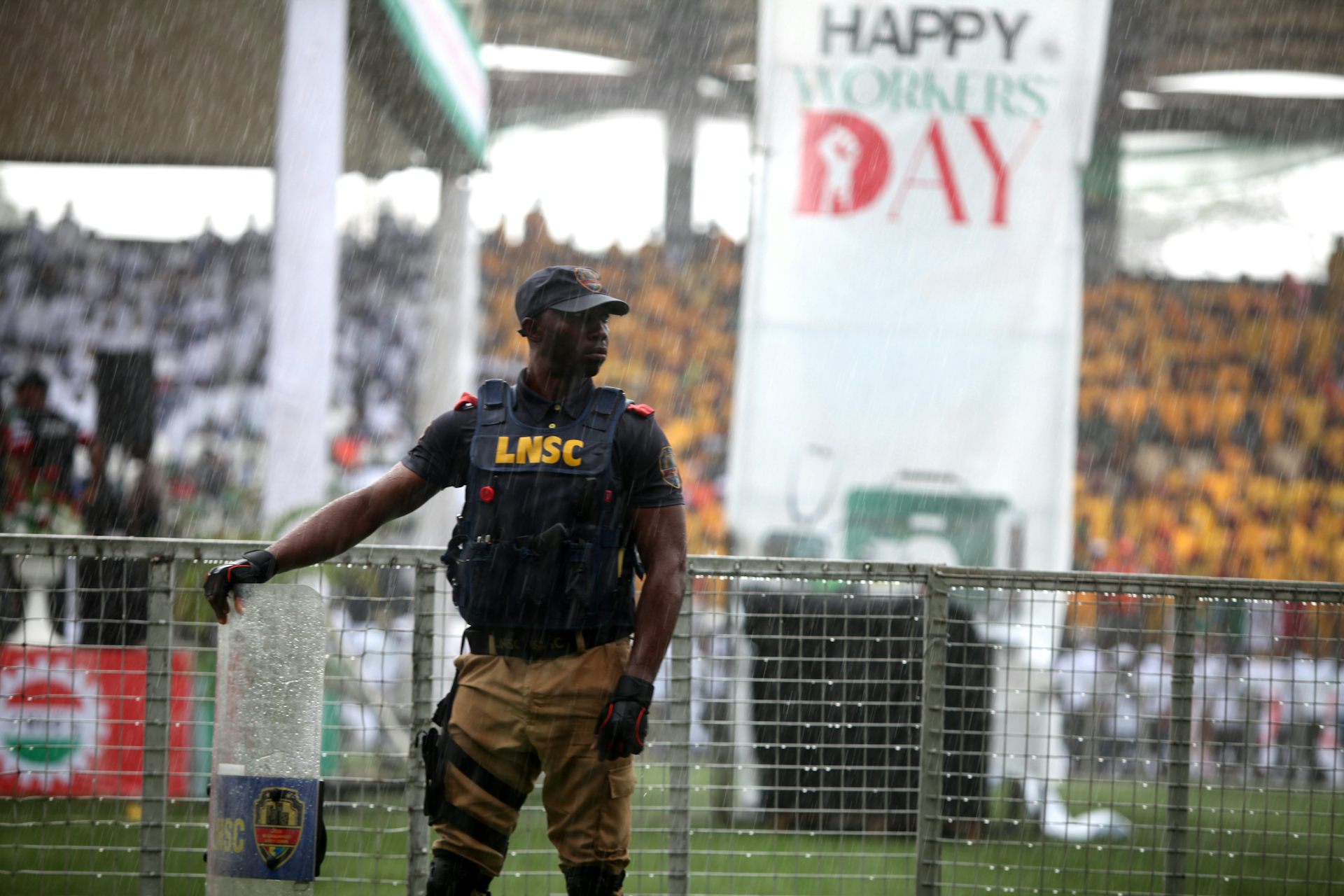 Man wearing a bulletproof vest, at a stadium