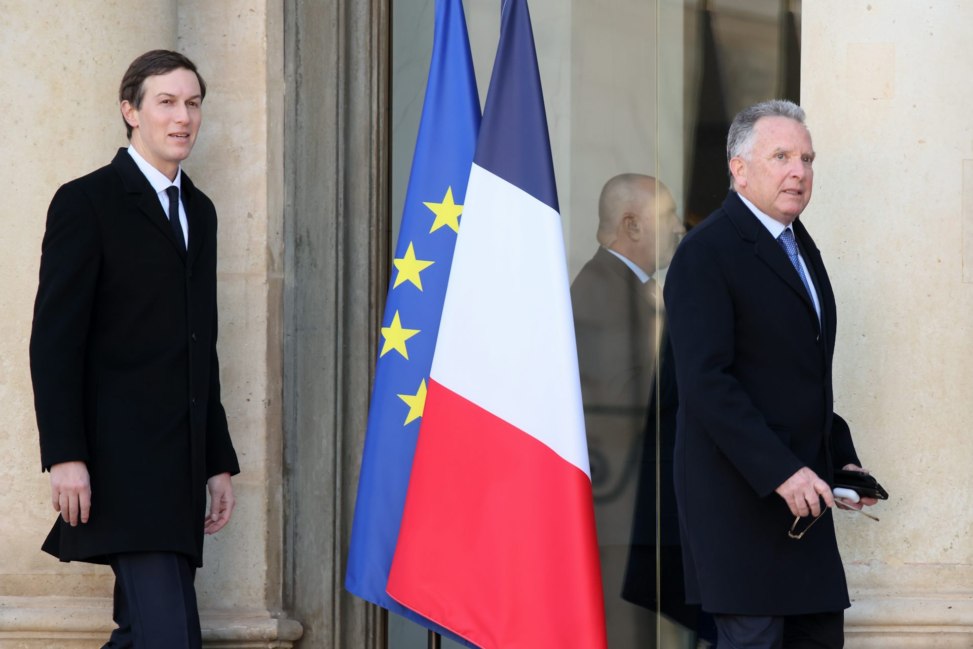 Jared Kusher and Steve Witkoff walk past the French and European Union flags outside a Paris meeting.