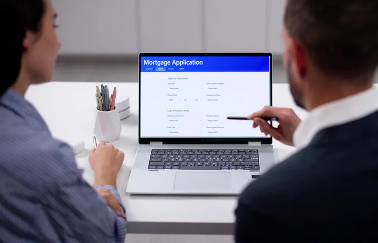 couple sitting at a laptop filling out an online loan application