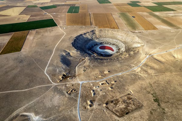 A large sinkhole near farm fields.