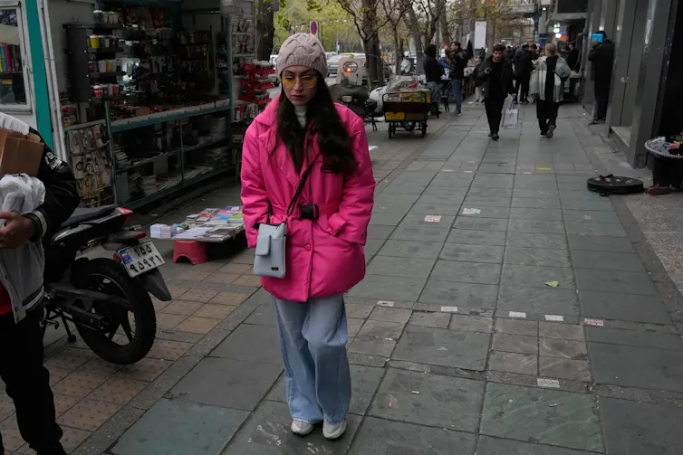 a woman walks down the street