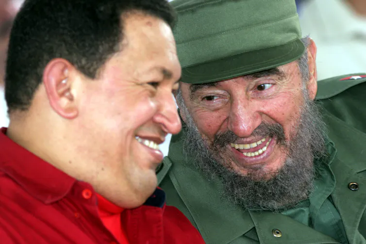 Two men joke and laugh with each other.