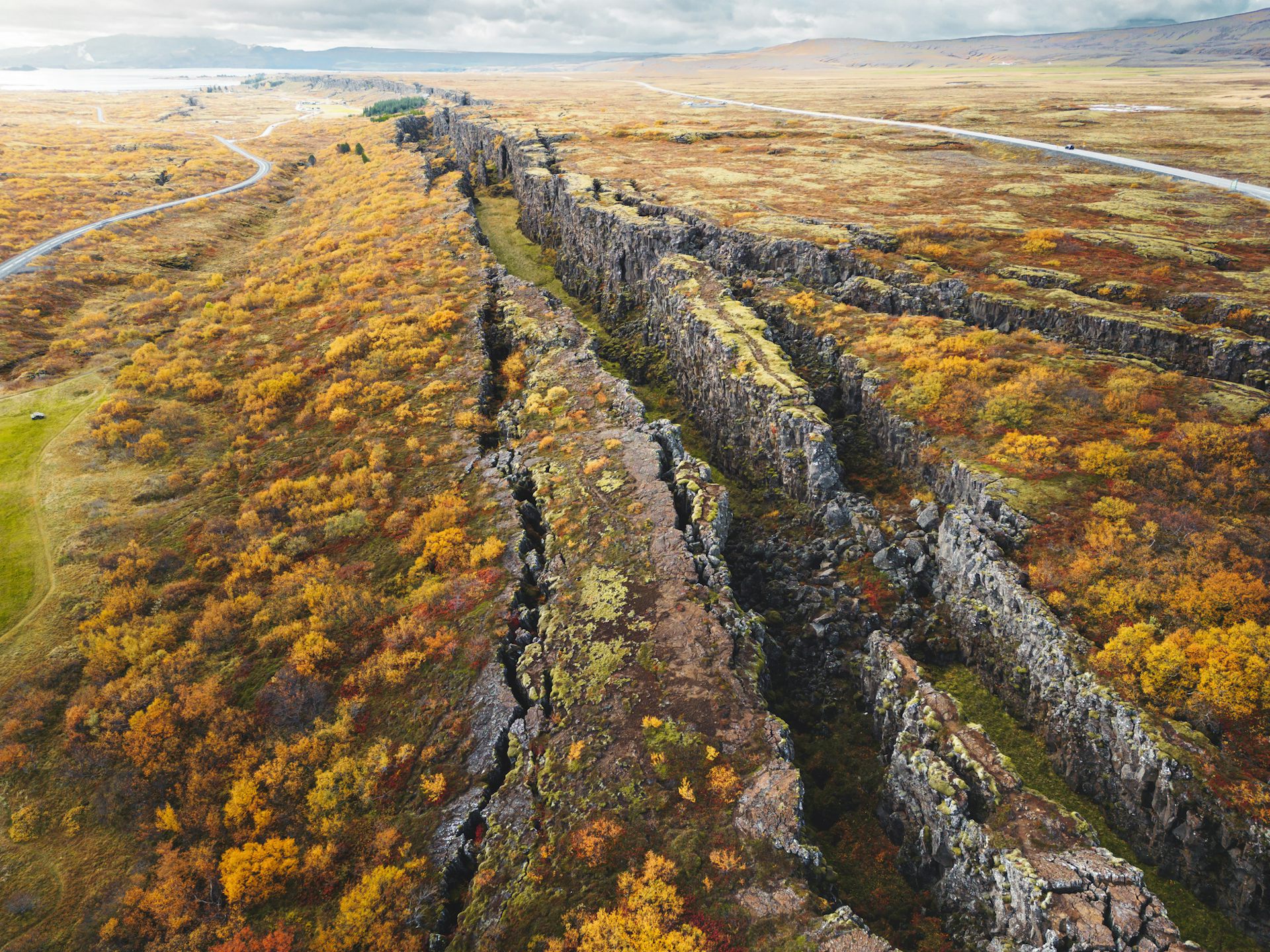 Aerial view of a mossy, craggy valley stretching across the landscape with steep rocky walls.