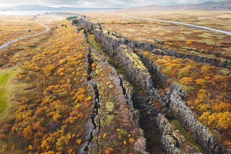 Aerial view of a mossy, craggy valley stretching across the landscape with steep rocky walls.