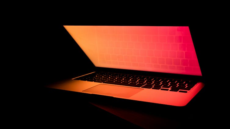 A laptop with a glowing red screen