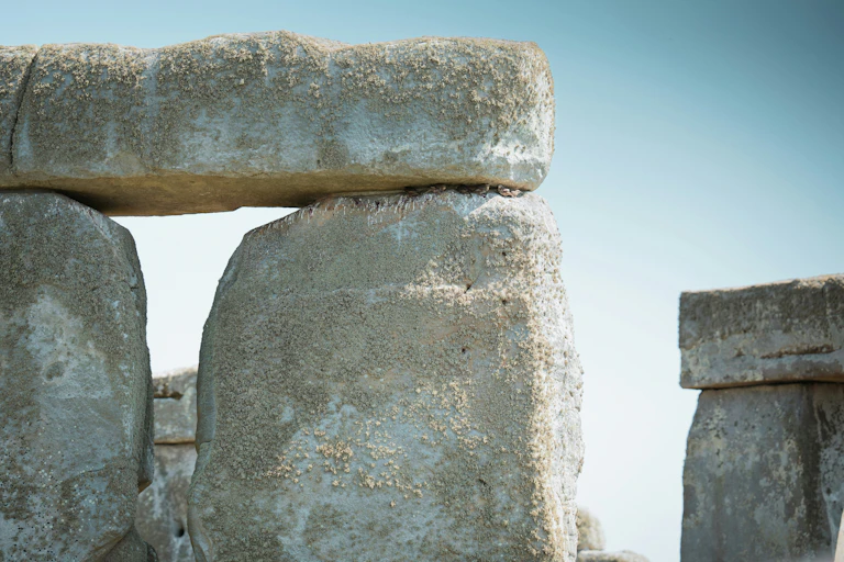 A close up of a stone structure with a sky background.