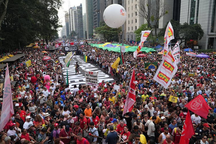 What triumphalist narratives about Brazil’s excessive courtroom and Bolsonaro imprisonment pass over 1 A massive crowd of people protest.