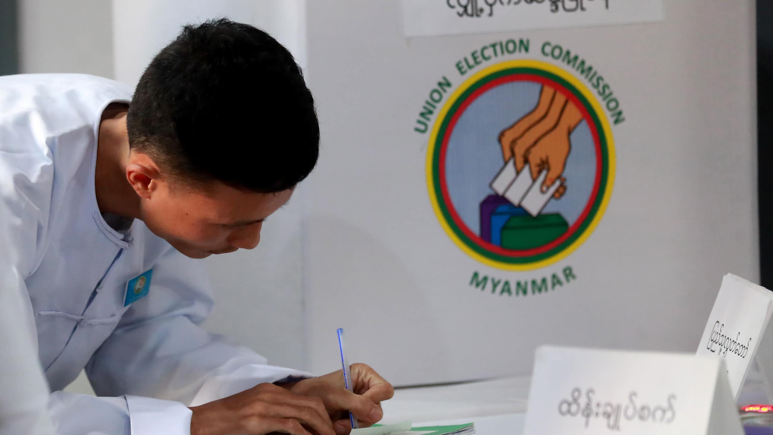 An electoral official signs on the result paper of an electronic voting machine after closing the second phase of the general election at a polling station in Yangon, Myanmar, 11 January 2026