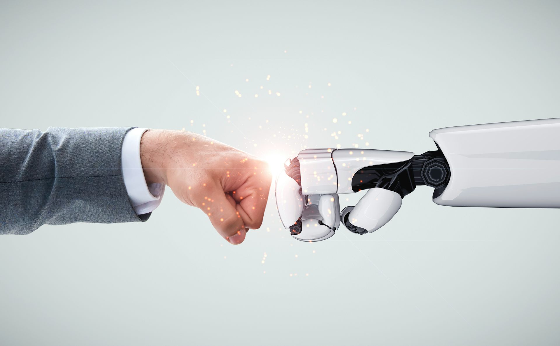 Fist bump between human and robotic fists.
