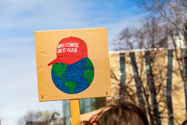A Maga-hat 'Make climate great again' protest sign