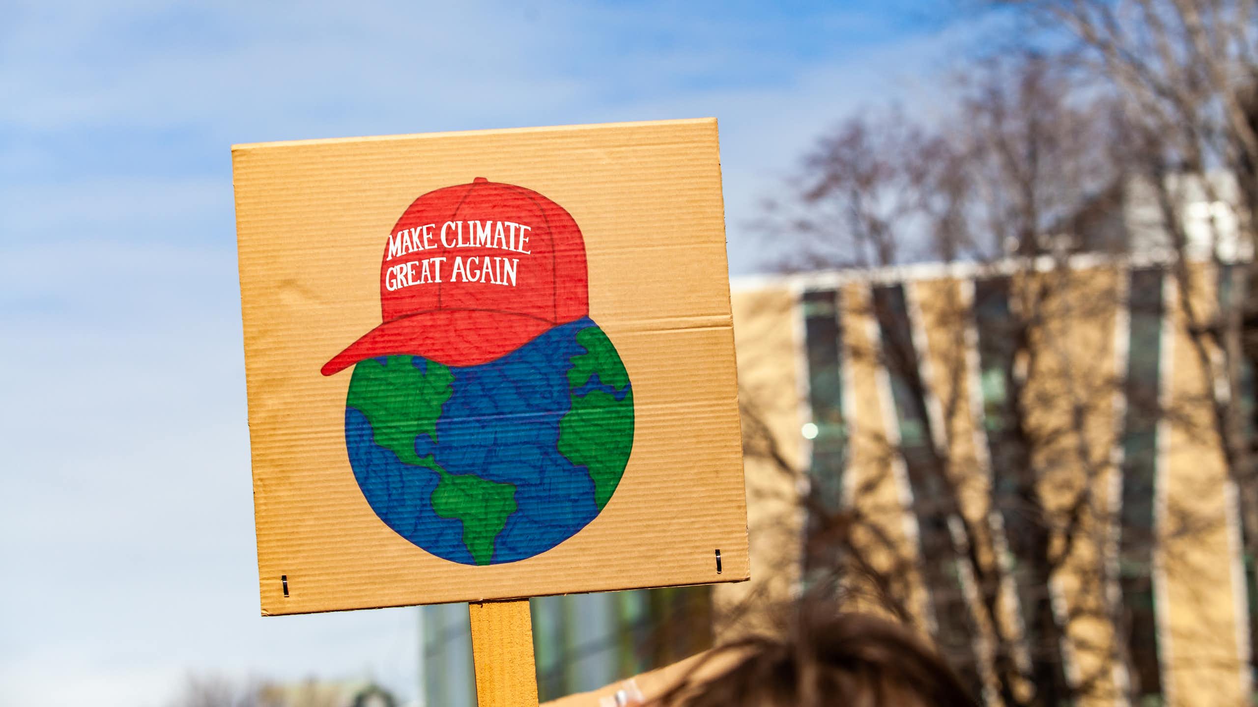 A Maga-hat 'Make climate great again' protest sign
