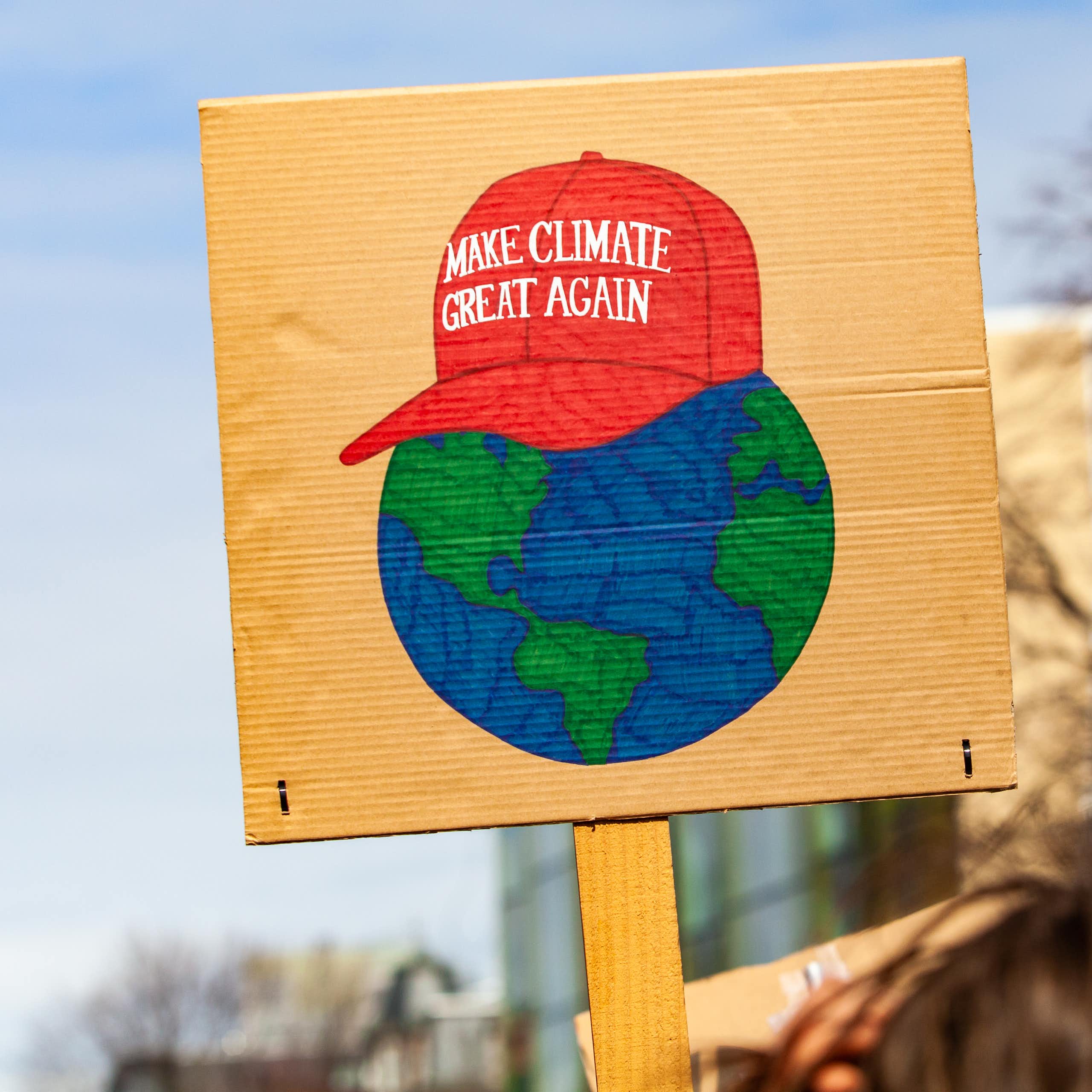 A Maga-hat 'Make climate great again' protest sign