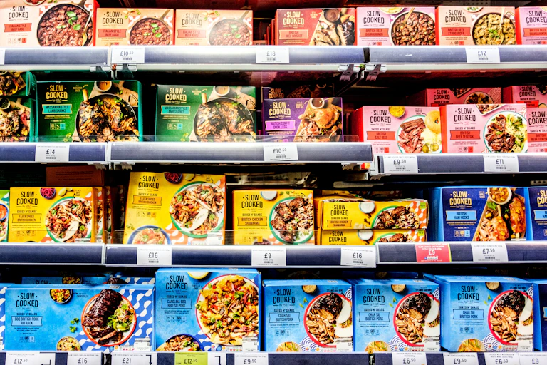 shelves of ready meals on display in a uk supermarket.