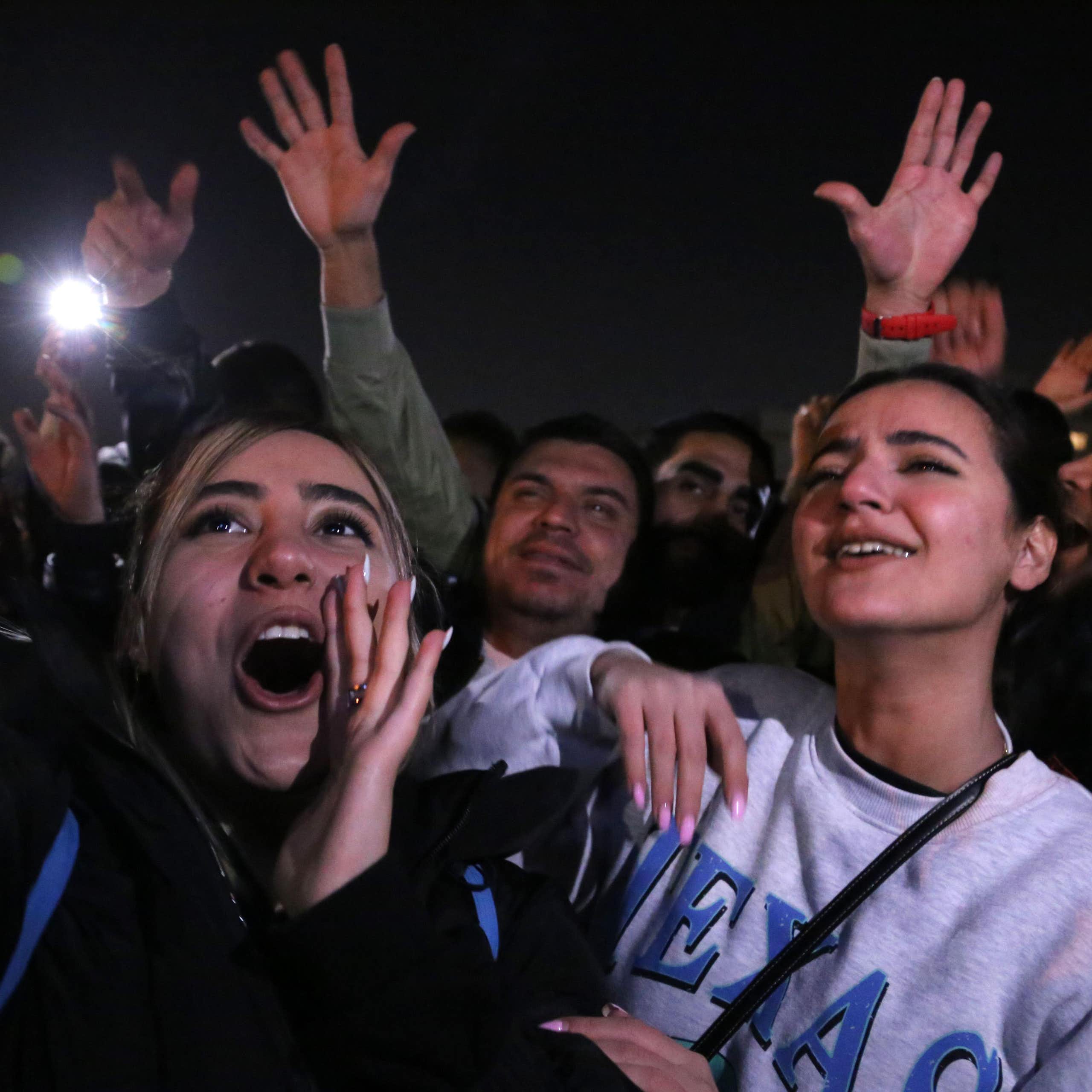 Two young Iranian women dancing in a Tehran nightclub without hijabs.without