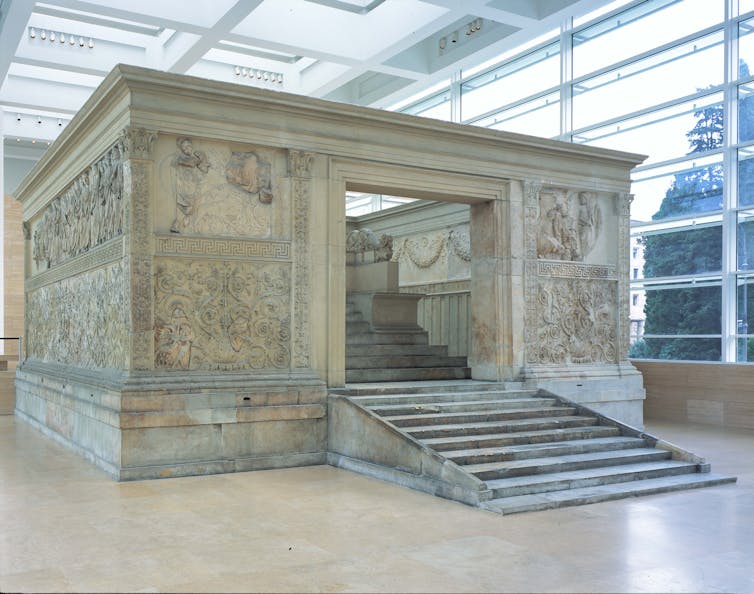 A large stone building that is an altar, with wide steps up to it.