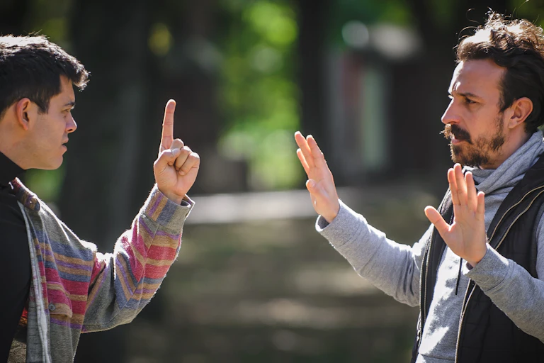 Two men in an angry confrontation outdoors