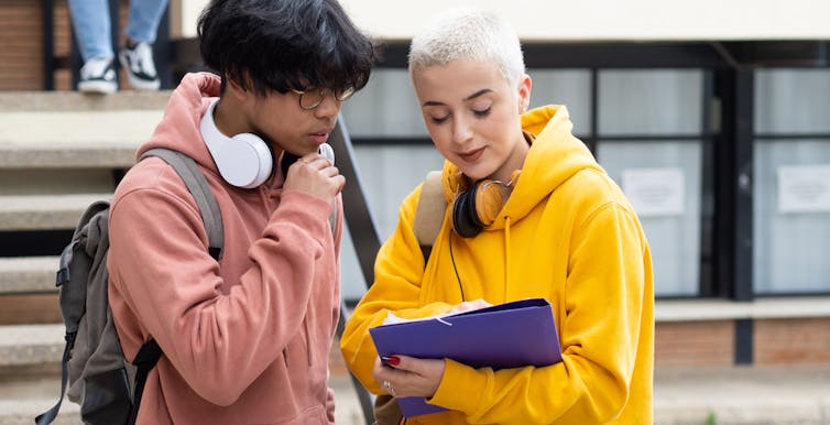 Students looking at information on paper