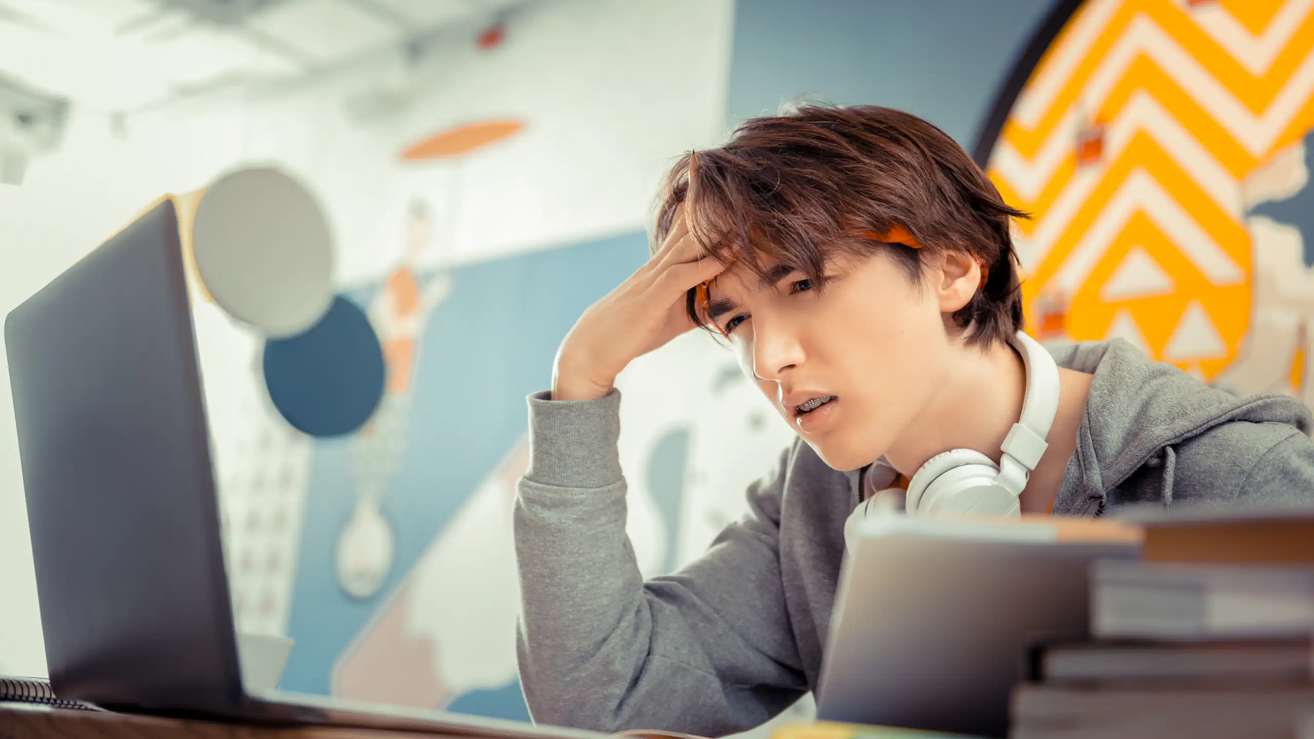 Boy squinting at computer screen