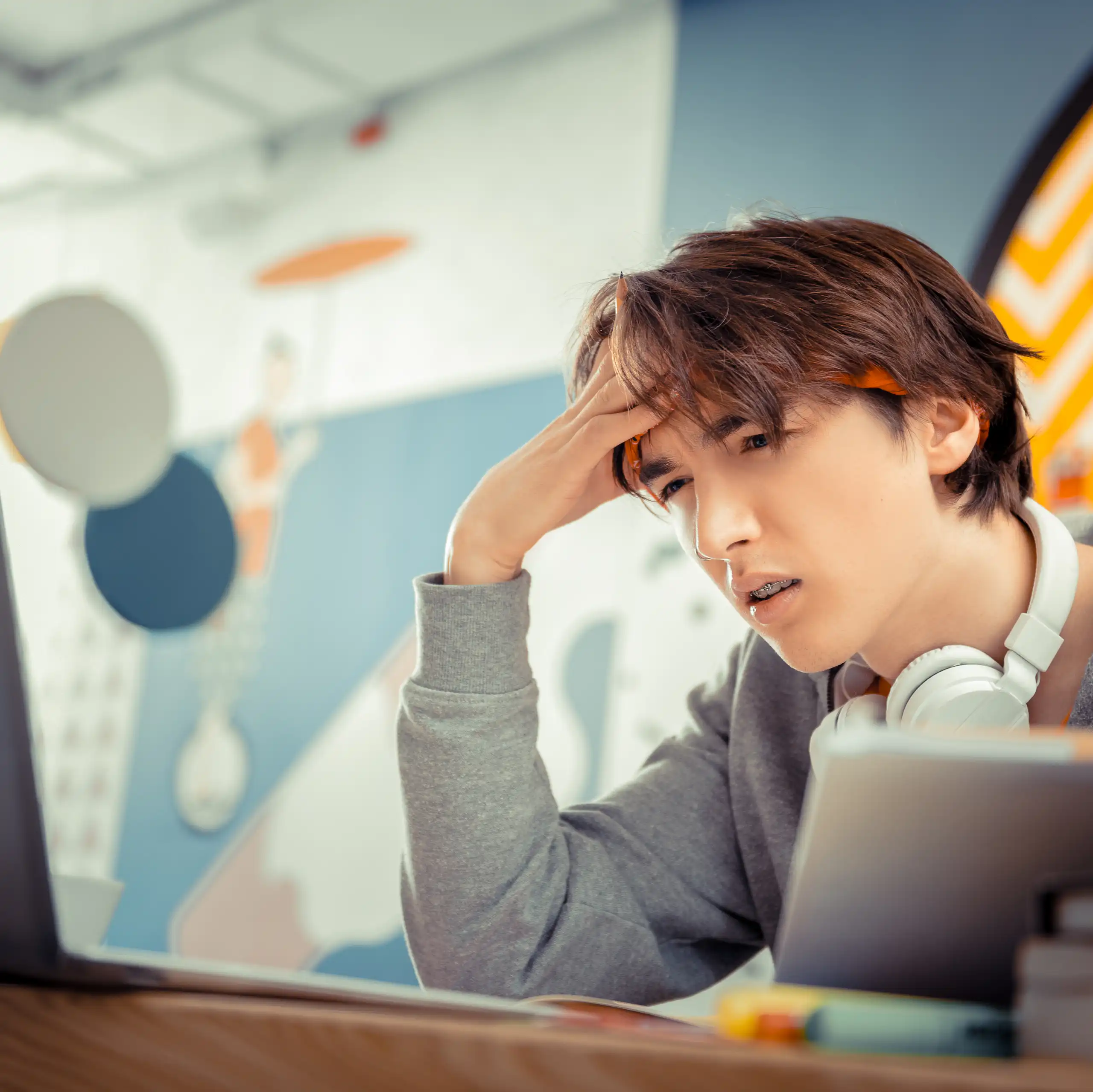 Boy squinting at computer screen