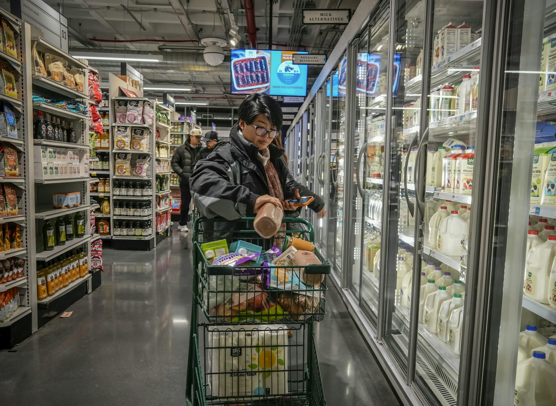 A customer filling a shopping cart in a supermarket in New York.