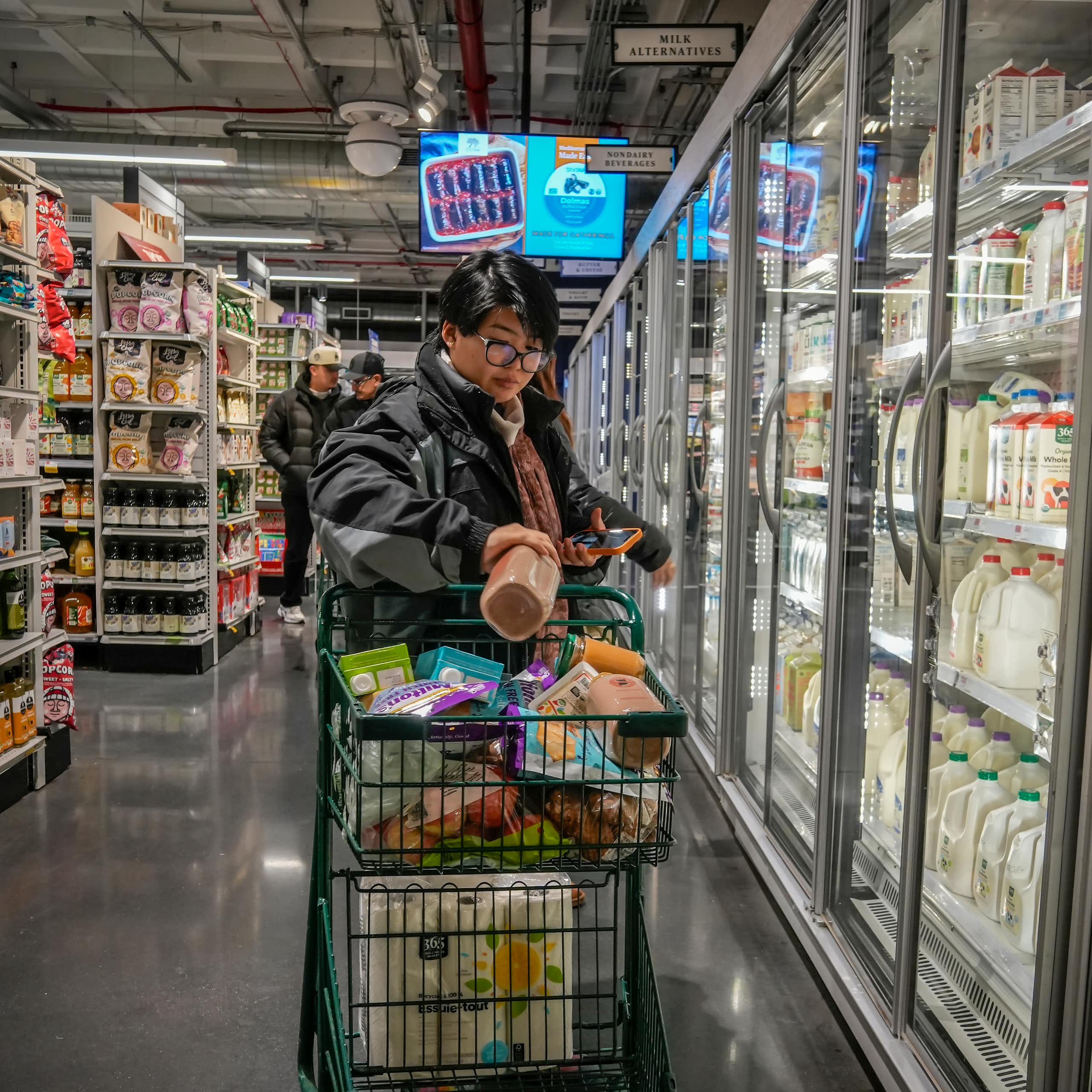A customer filling a shopping cart in a supermarket in New York.